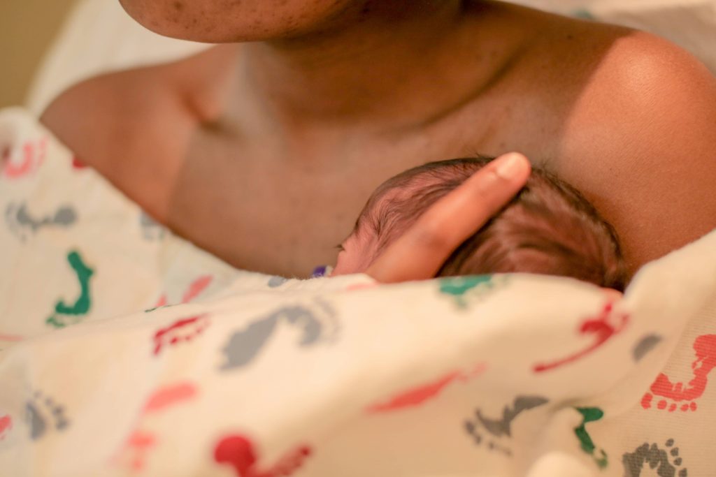 Baby newborn receiving body skin to skin contact